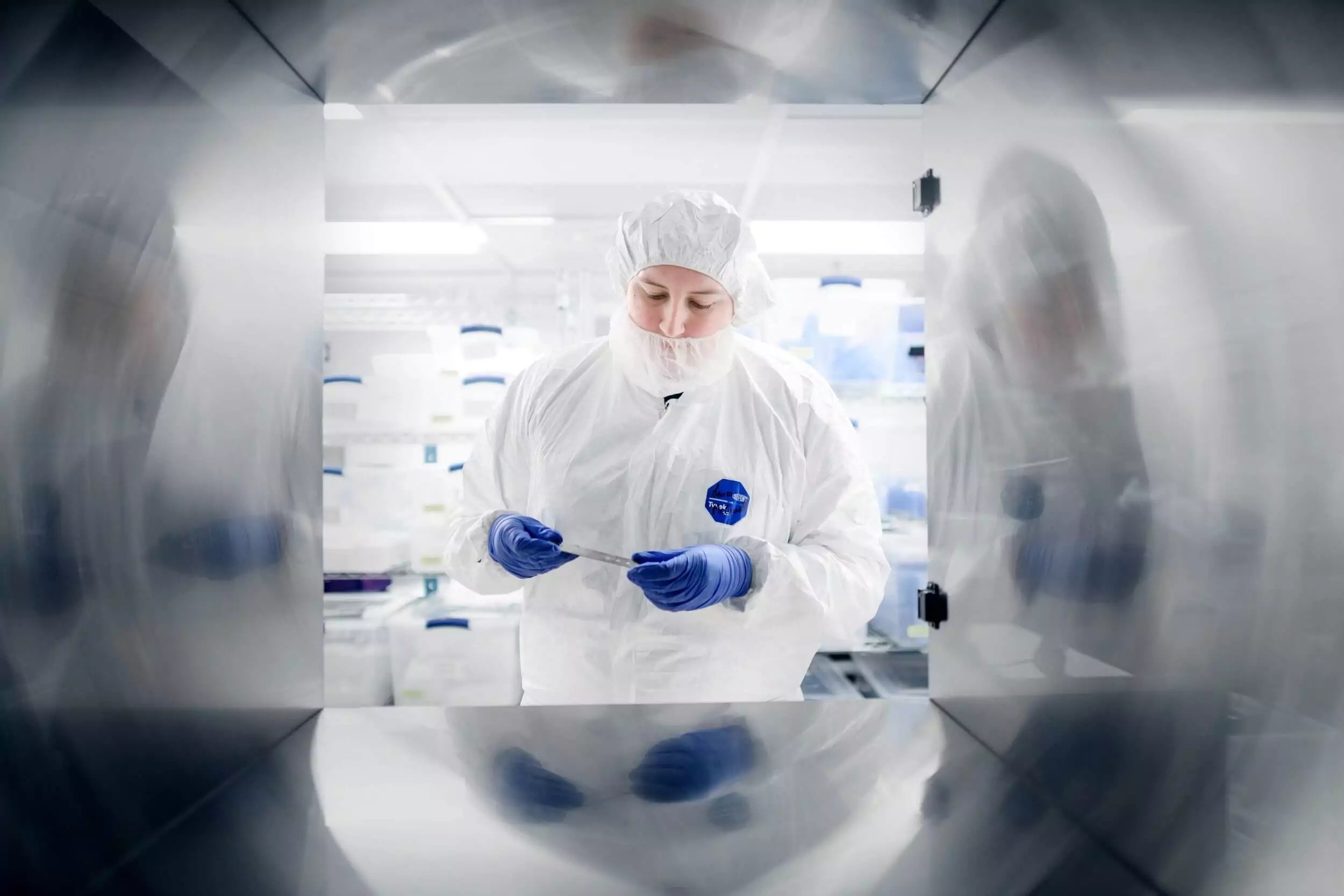 Scientist analyzing medicala device component in laboratory.