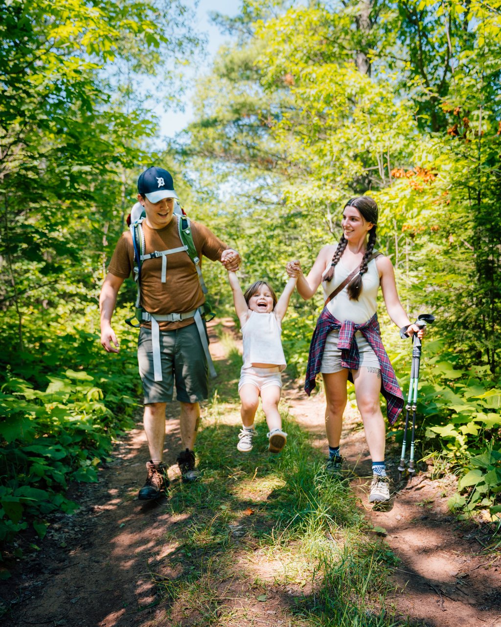 Family hiking through Mt. Baldy Trail in Michigan.
